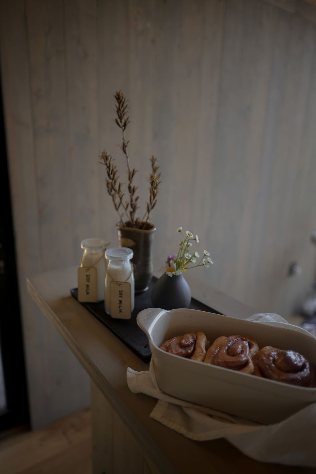 Cabin kitchen with open shelves and a door to the woods